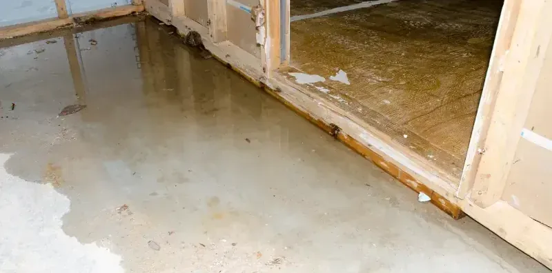 Standing floodwater spread across a floor after a flash flood inside a home