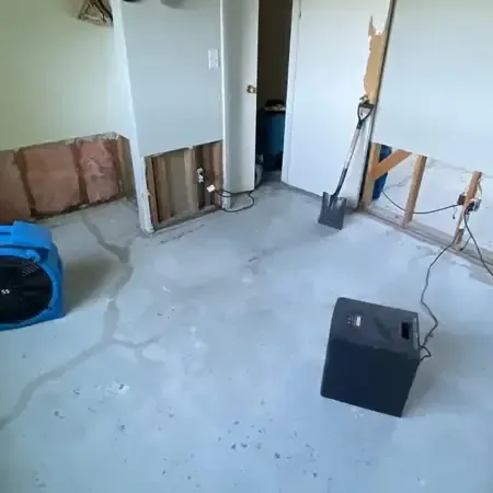 Sealed containment barrier and air scrubber set up in a room after a sewage backup